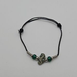 black slider bracelet with green and cream seahorse bead